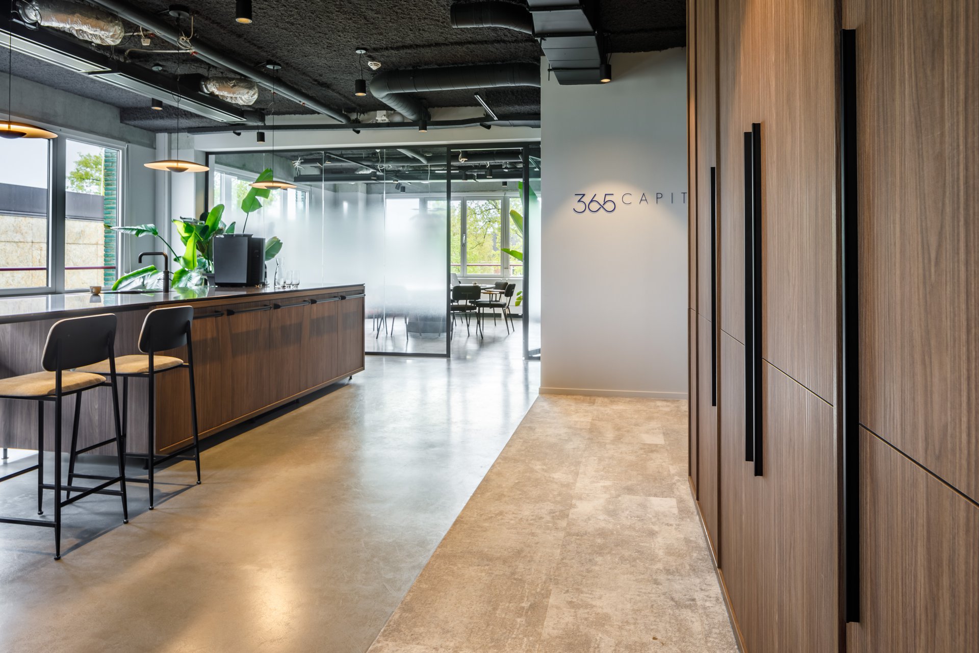 Interior design showcasing a collaborative workspace with ample daylight and bold column structure