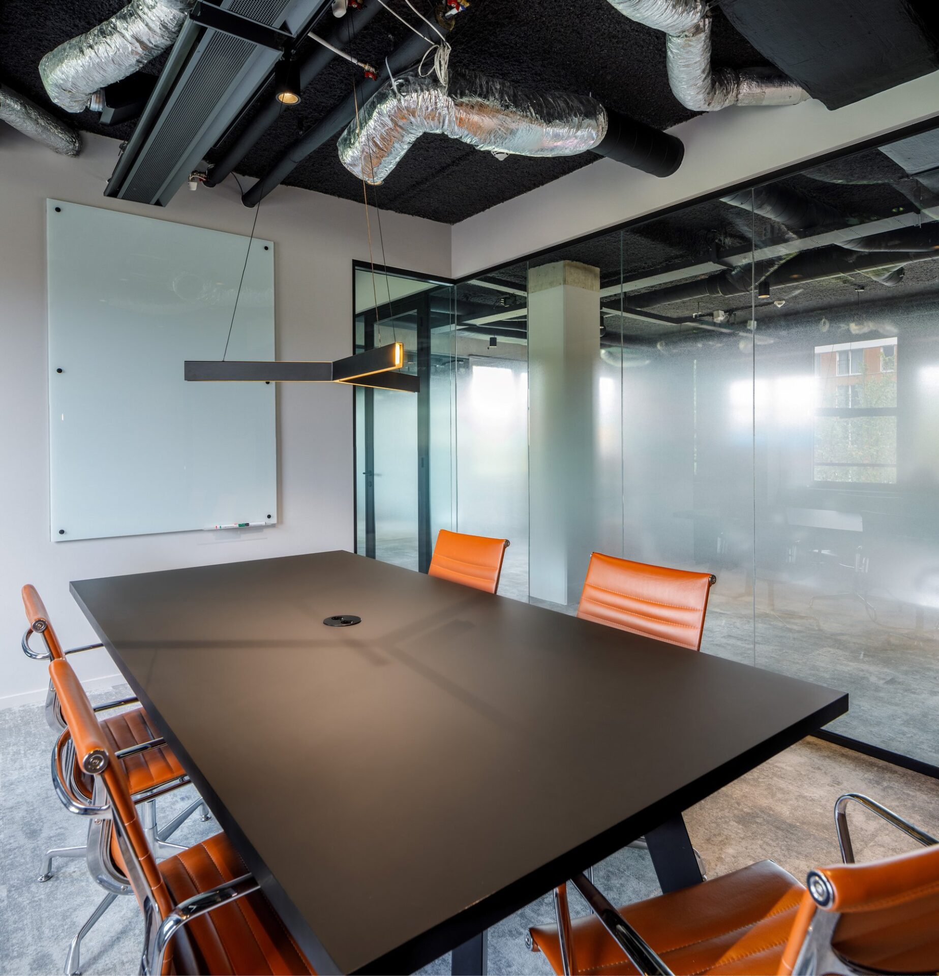 Interior design showcasing a collaborative workspace with ample daylight and bold column structure