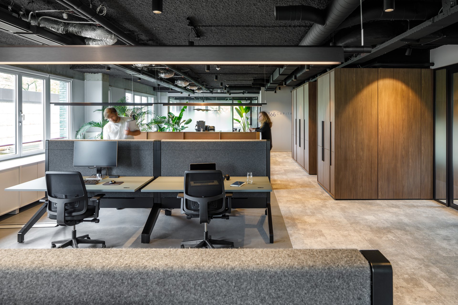 Interior design showcasing a collaborative workspace with ample daylight and bold column structure