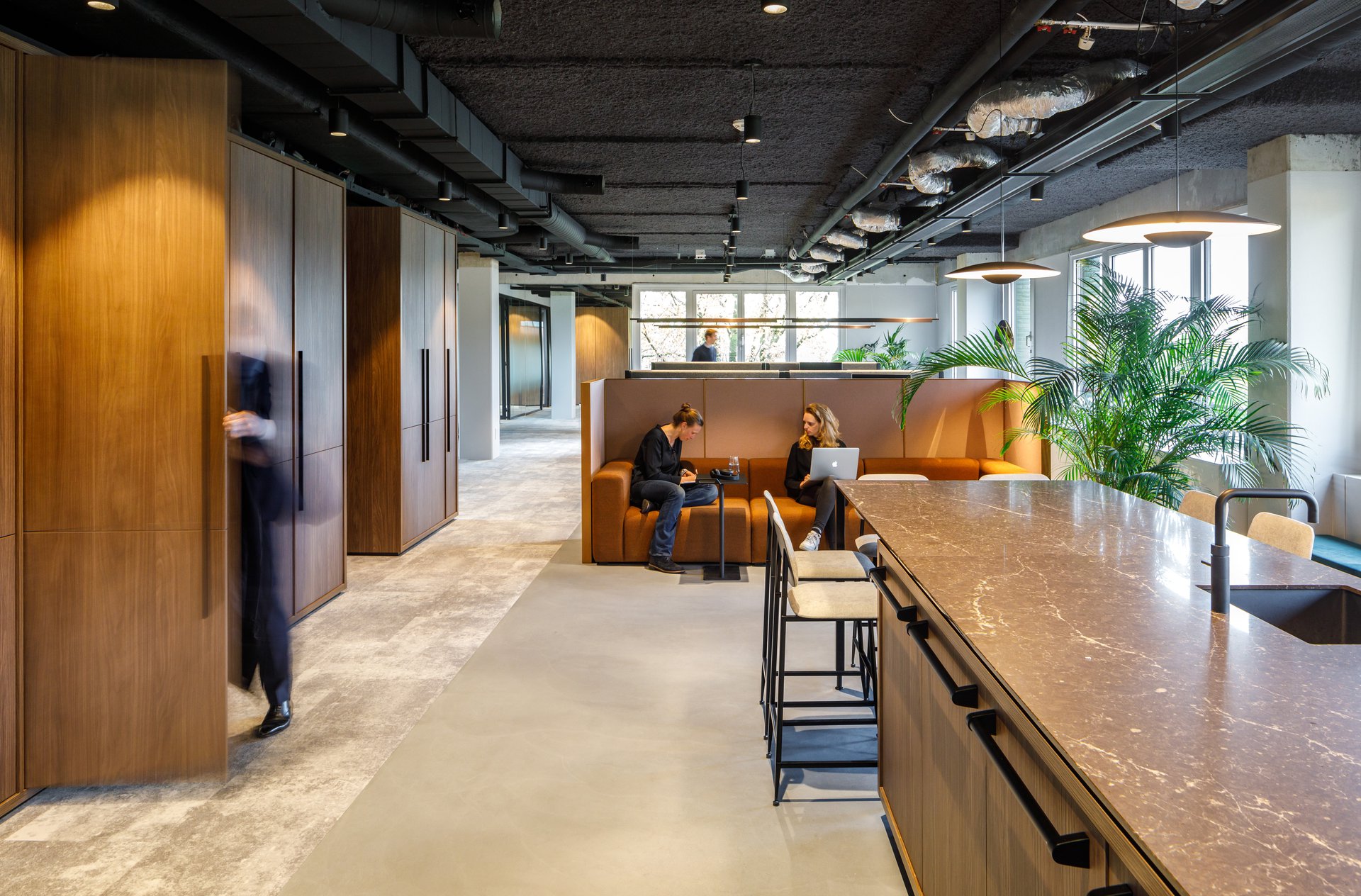 Interior design showcasing a collaborative workspace with ample daylight and bold column structure