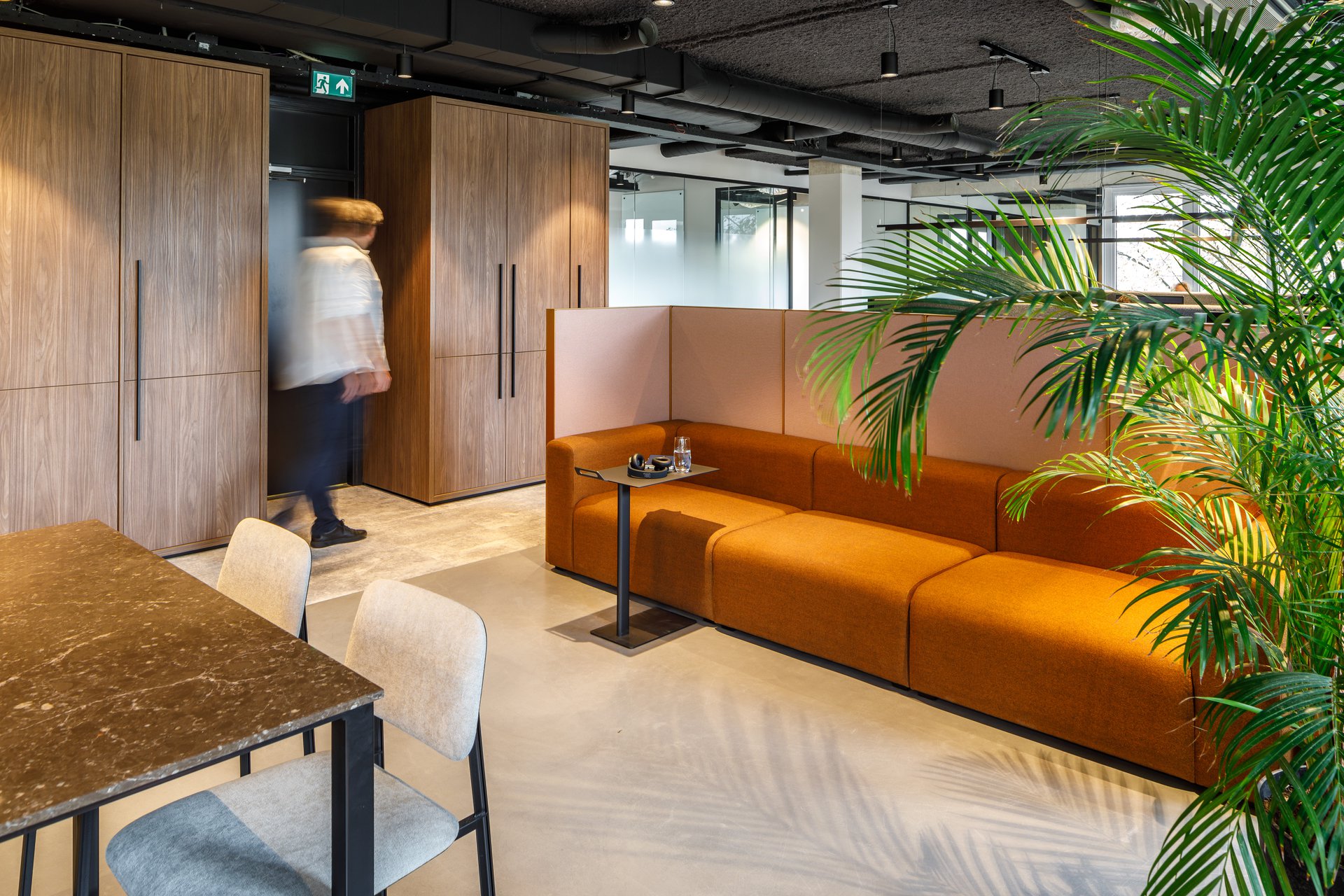Interior design showcasing a collaborative workspace with ample daylight and bold column structure