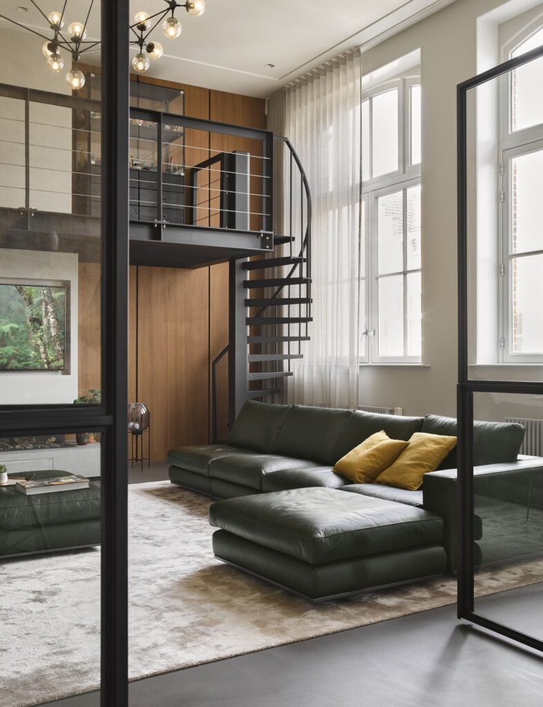 Interior view with high pitched windows and a pristine white kitchen.
