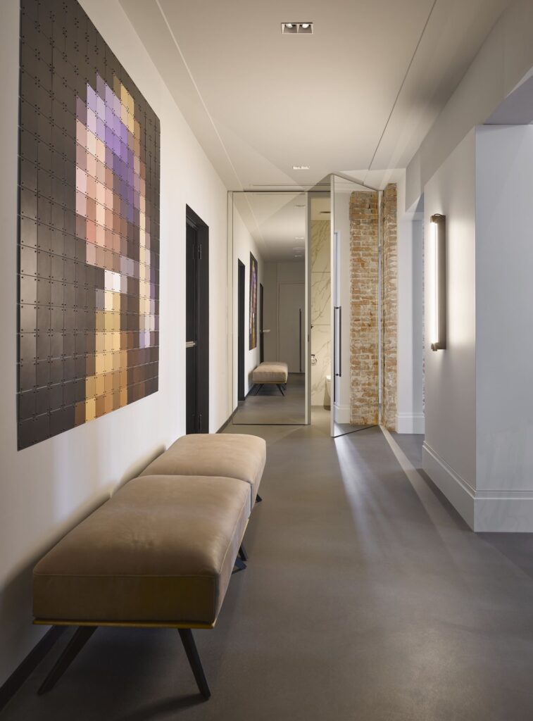 Hallway mirror extending sightlines with hidden doors.