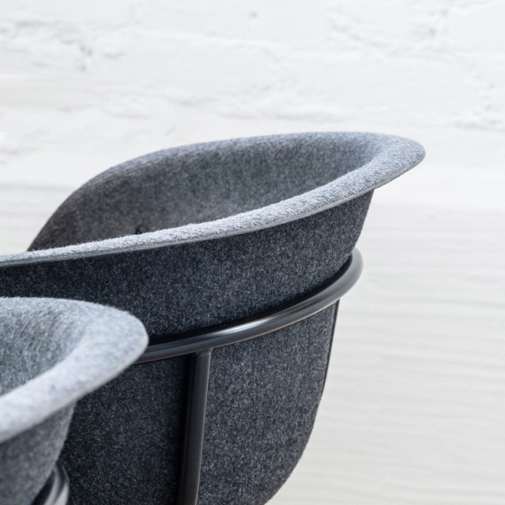 The CARRII chair with replaceable parts and a colourful cushion.