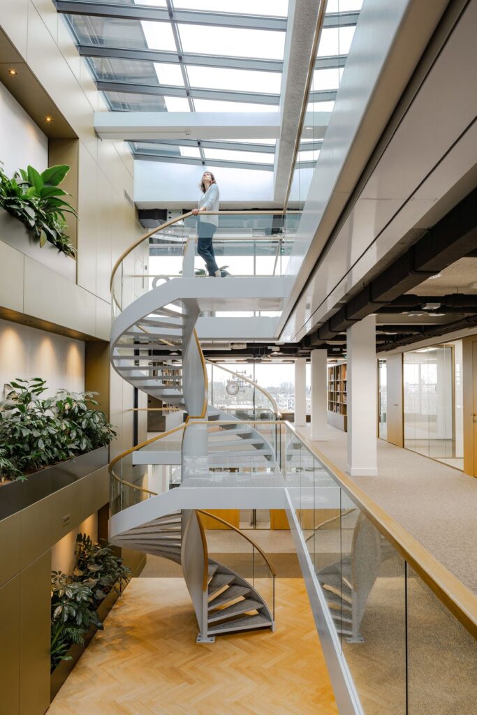 Interior view with spiral staircase and greenery