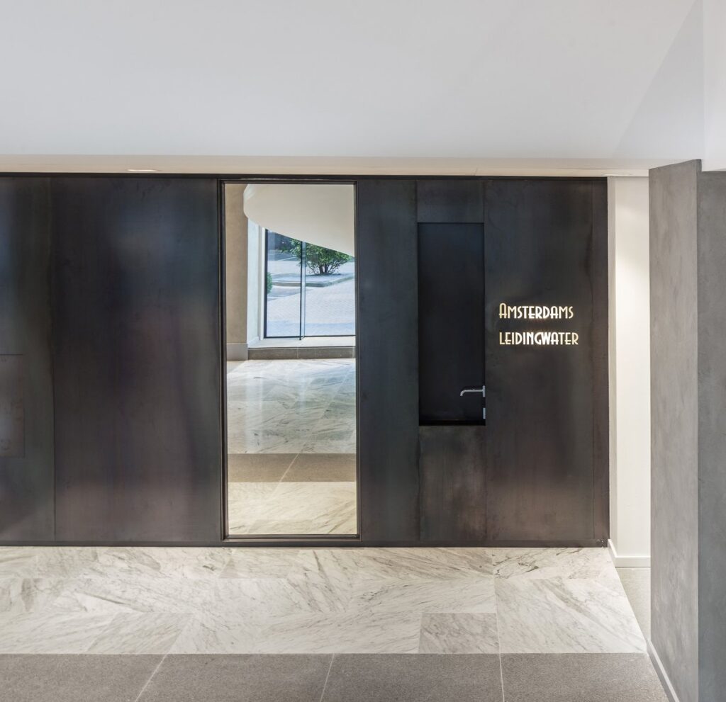 New entrance hall with marble spiral stairs and reception area