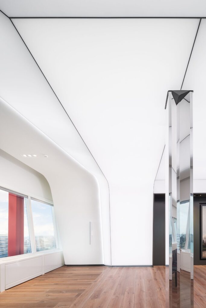 An integral wing-shaped design of walls and ceiling frames a painting by Hobbe Smith