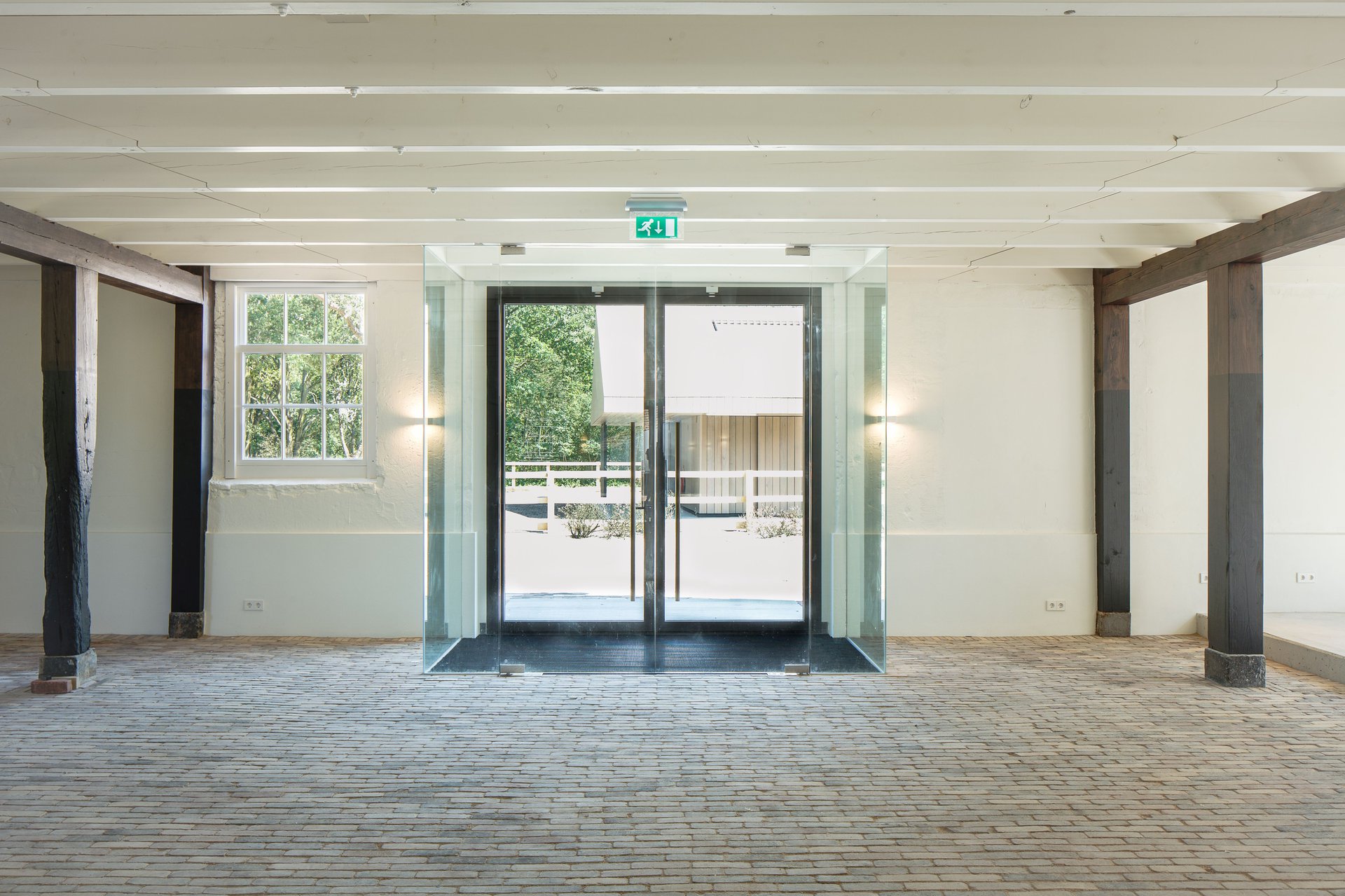 Historic barn in decay converts to visitor center as part of the transformation of a farm ensemble