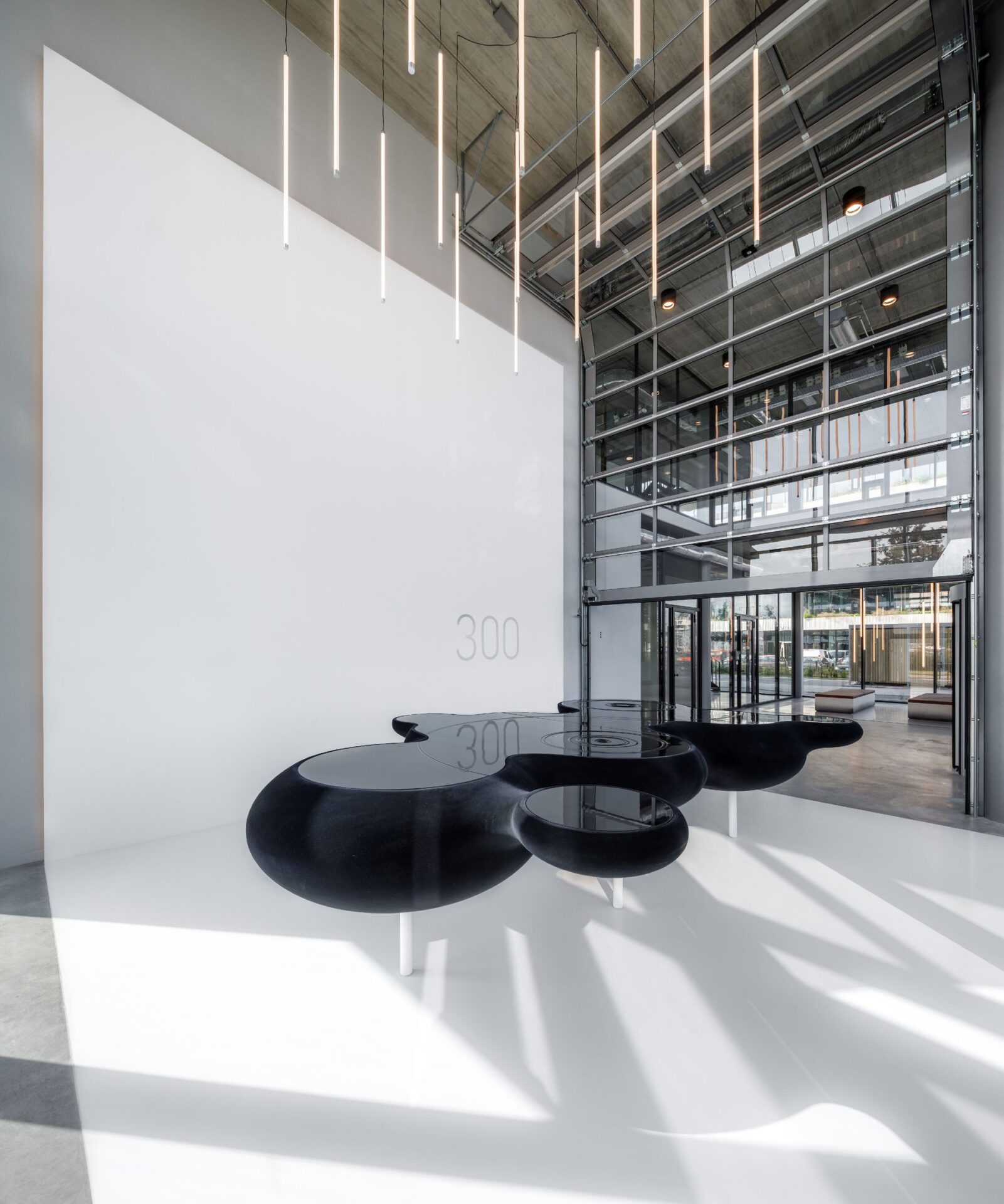 Minimalistic pieces of custom furniture stand out against a gallery inspired interior