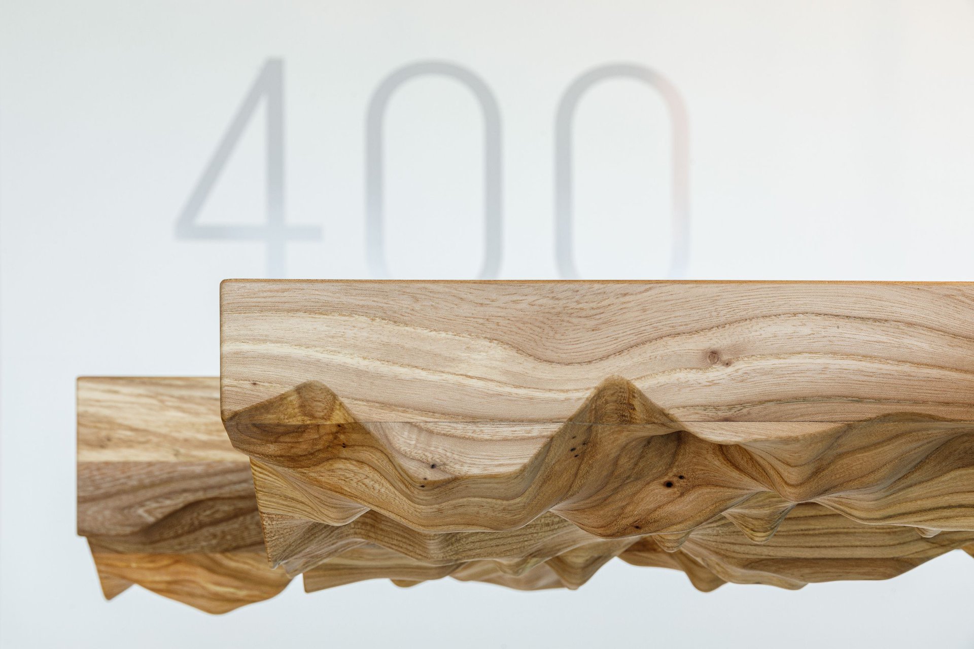 Minimalistic pieces of custom furniture stand out against a gallery inspired interior