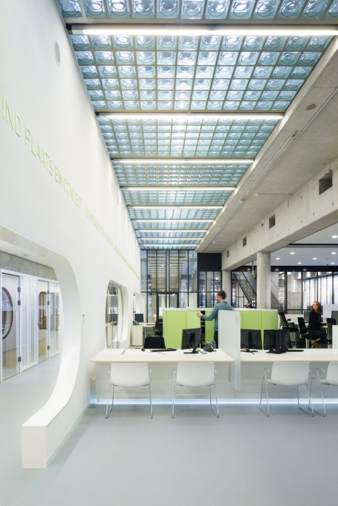 Interior of city hall Almere showing bare concrete structure and golden tiles