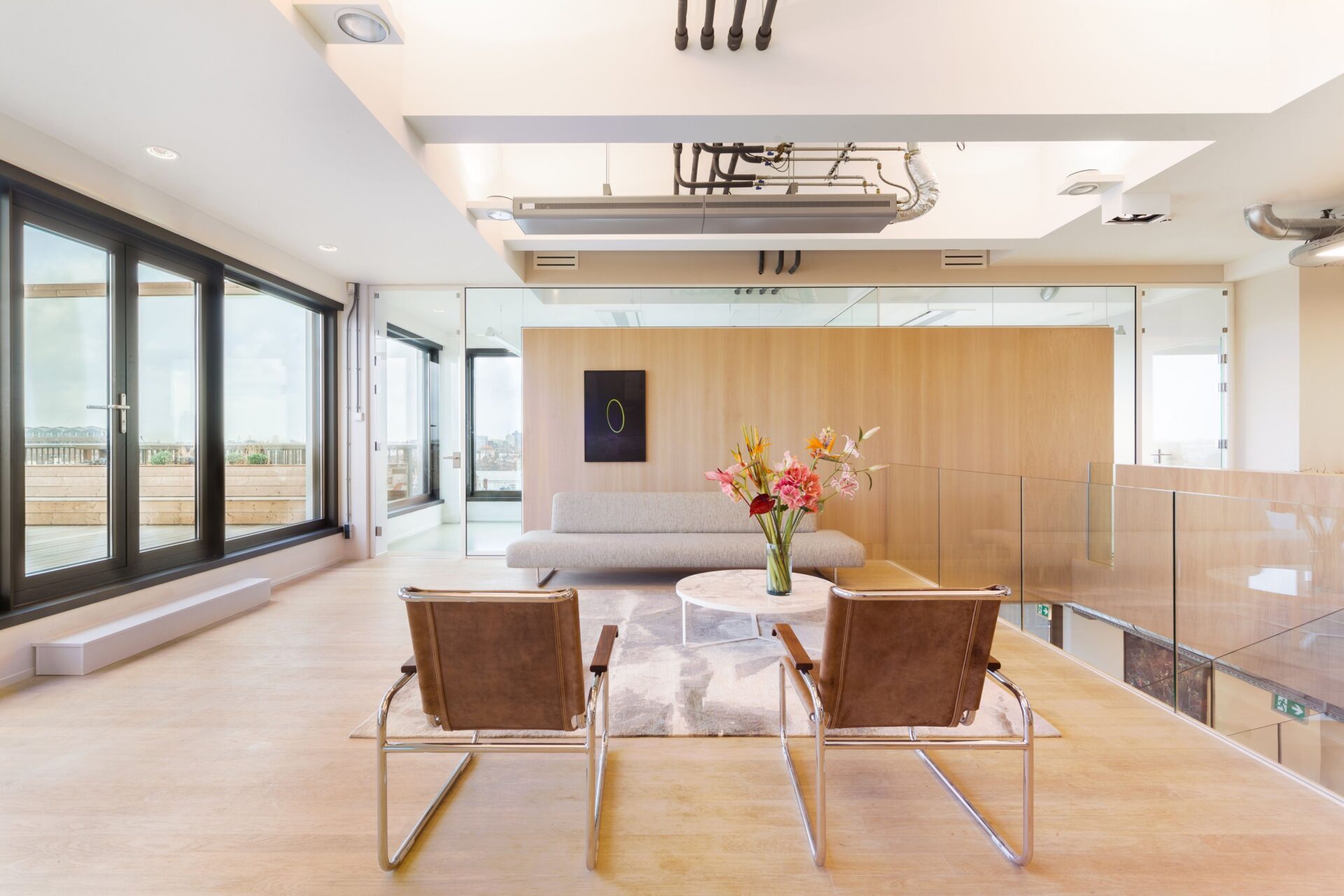 Interior view of the office with modern furniture and lighting.