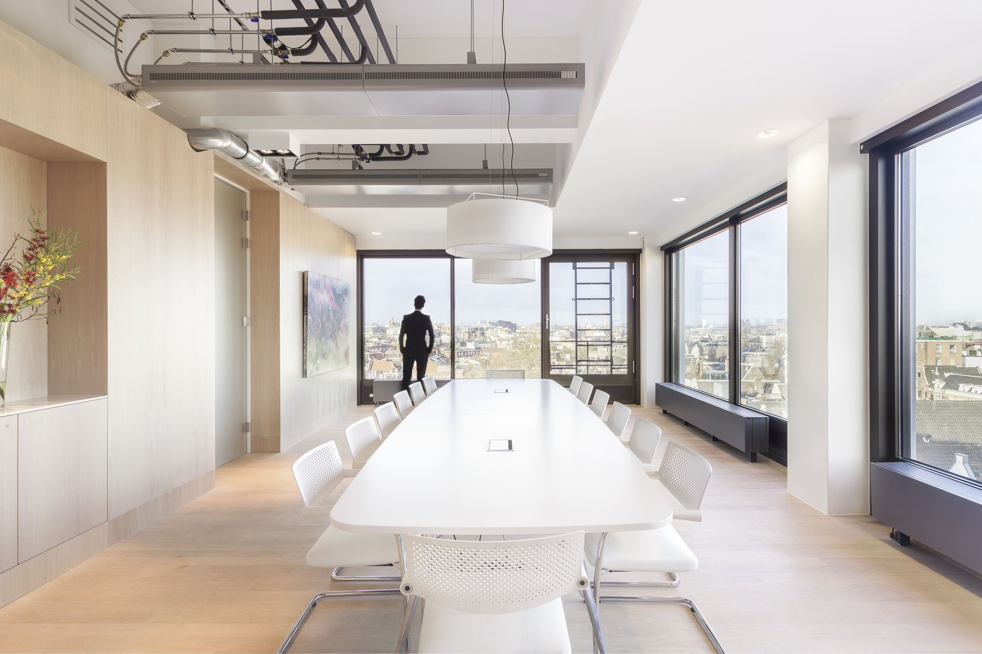 Office space with modern furniture and concrete structure.