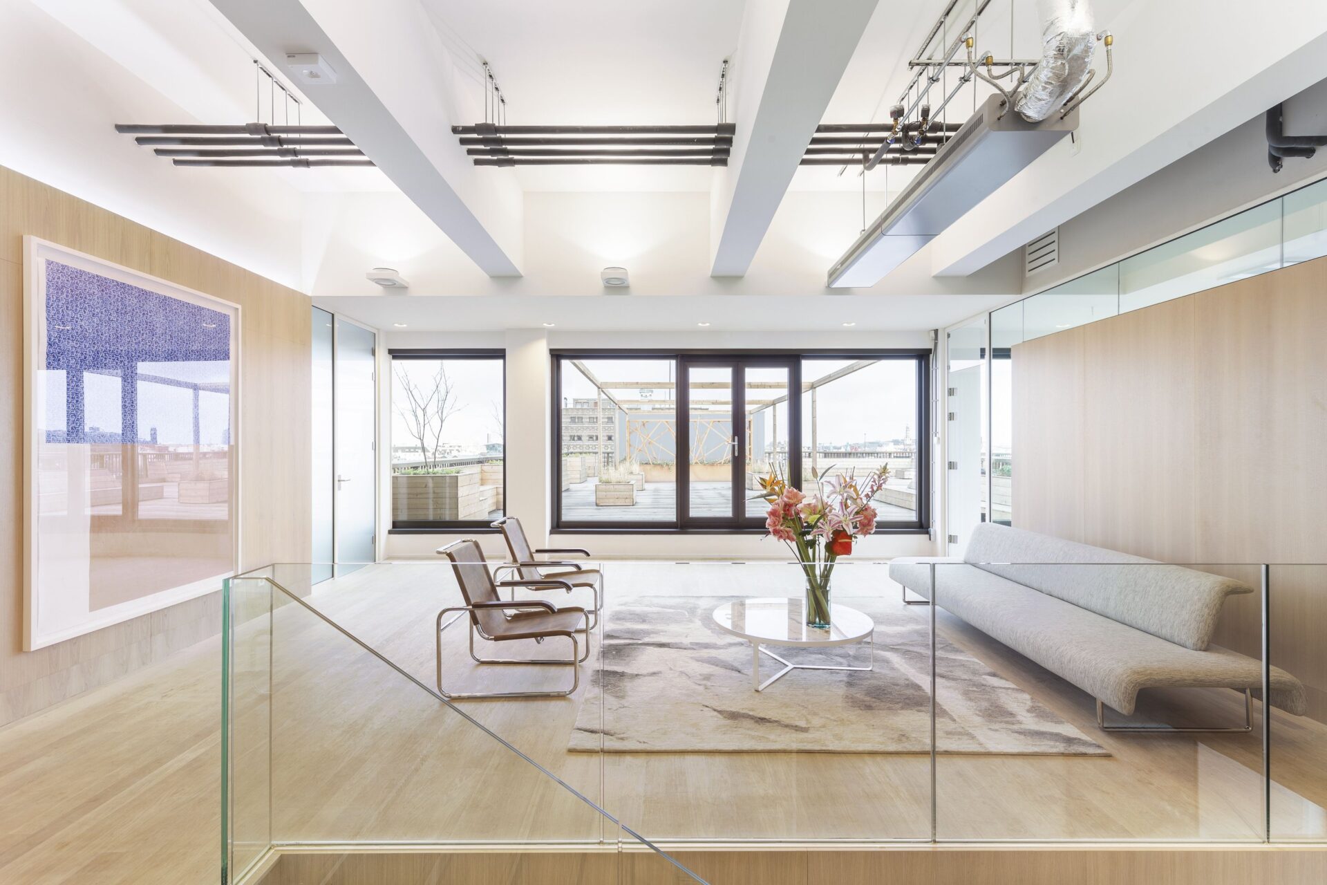 Office space with glass walls and natural light.