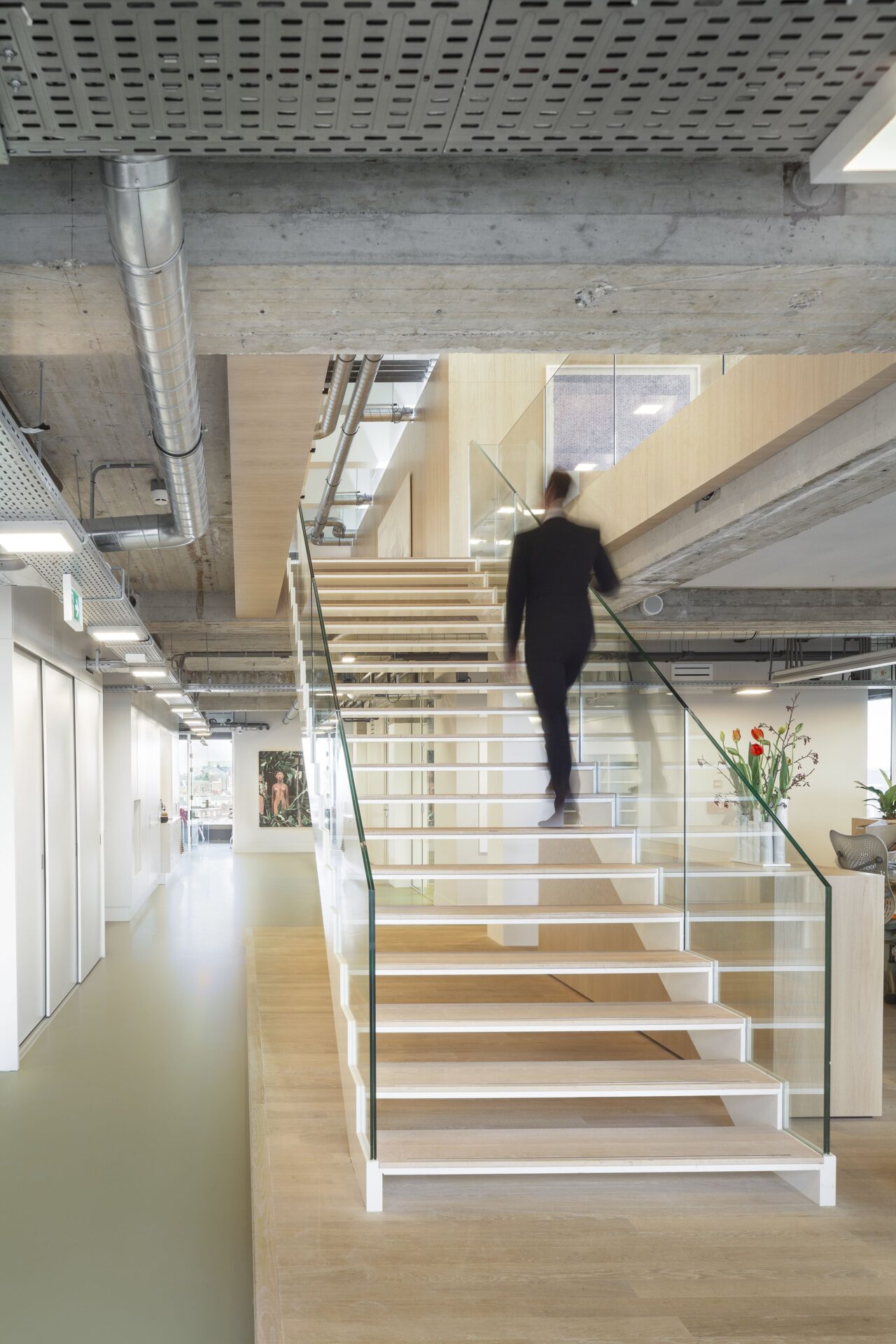 Meeting room with glass walls and concrete structure.