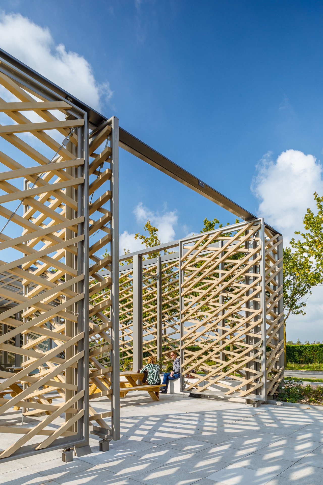 A timber façade wraps itself around the new build extension of the workshop