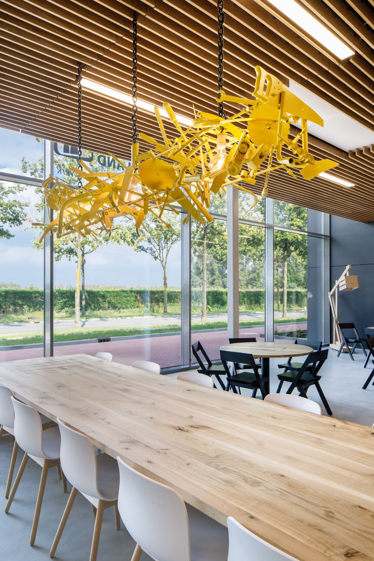 A bright yellow tools lamp was made for the restaurant from old tools