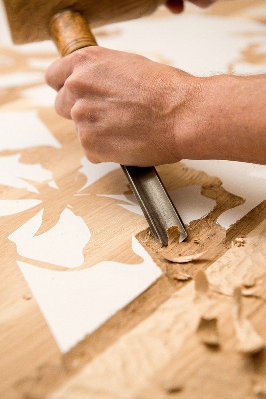 Hand-carved oak tables and felt wall panels